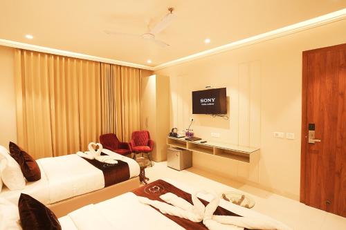 TV a/nebo společenská místnost v ubytování Hotel Green Land Heights