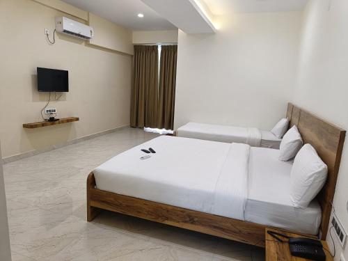 a bedroom with a bed and a television in it at RK COMFORTS in Bengaluru