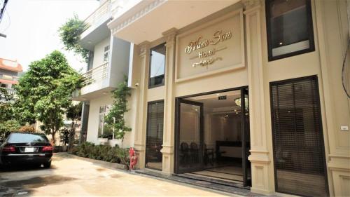 a store front of a building with a car parked outside at NAM SON HOTEL in Ha Long