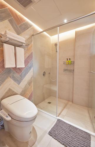 a bathroom with a toilet and a shower at 星澄風旅 Zela Design Hotel in Kaohsiung