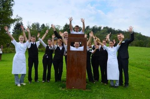 a group of people standing behind a wooden monument at Badhotel Restaurant Stauferland in Bad Boll