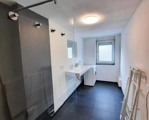 a white bathroom with a sink and a shower at home2stay worker house Nürtingen HS29 in Nürtingen