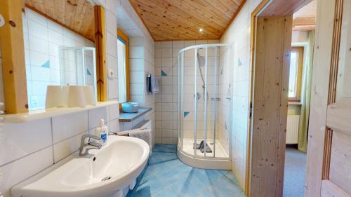 a bathroom with a sink and a shower at Chalet Tirol Waidring in Waidring