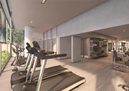 a gym with treadmills and ellipticals in a room at Noon Vila Madalena in Sao Paulo
