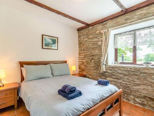 a bedroom with a bed with towels on it at The Stable in Llandysul