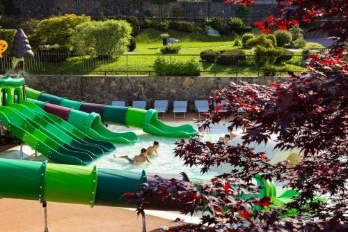 a water slide at a water park with people in it at Harmony Suite Hotel in Selvino