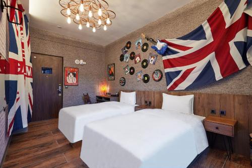 a hotel room with two beds and a flag at 星澄風旅 Zela Design Hotel in Kaohsiung