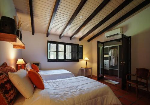 a bedroom with two beds in a room at Posada La Celia in Eugenio Bustos