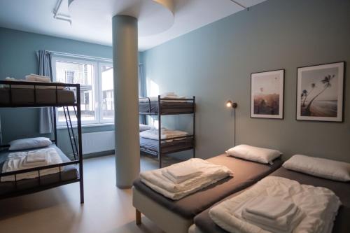 a room with three bunk beds and a window at Anker Apartment – Grünerløkka in Oslo