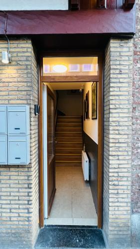 a hallway of a house with a staircase and a door at SalzinnesChezSoi 2 in Namur