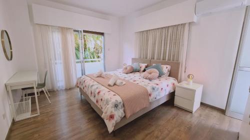 a bedroom with a bed and a desk and a window at STAY Vital Elegance in Limassol