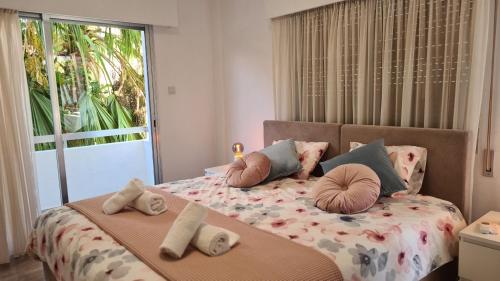 a bedroom with a bed with pillows and a window at STAY Vital Elegance in Limassol