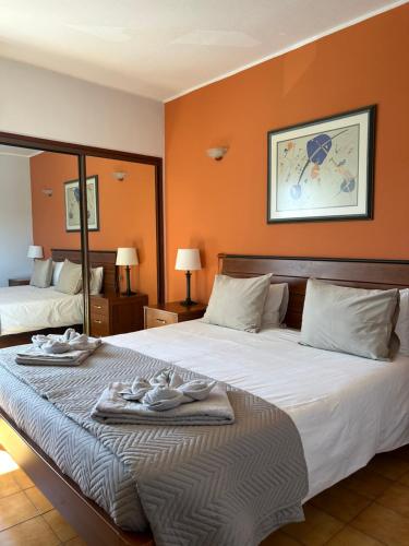 a hotel room with two beds with towels on them at Apartamento A11 - 800m da praia in Albufeira