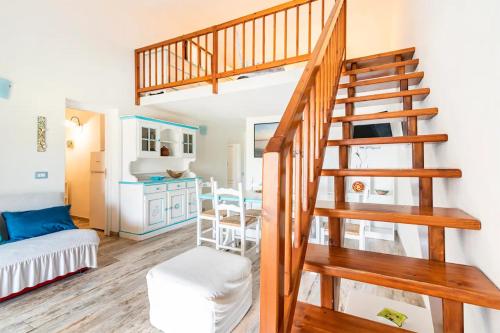 a living room with a staircase and a kitchen at Cala Paradiso Apartment "Casa Agave" - SeaView, Wifi, AC in San Teodoro