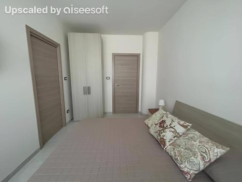 a room with two doors and a bed with a pillow at Villa Bellavista in Martina Franca