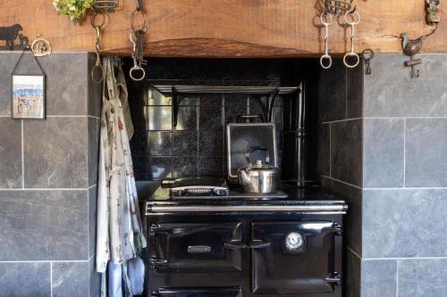 a kitchen with a stove with a pot on it at Marsh Farm in Bridgwater