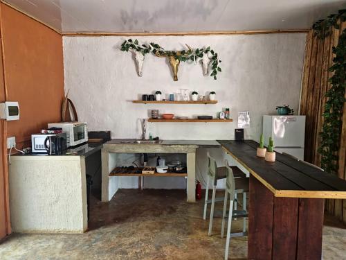a kitchen with a counter and a table and a refrigerator at Vulture's View 3 in Hartbeespoort