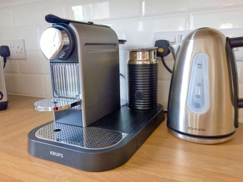 a coffee maker sitting on a counter next to a coffeeilit at Chy Bownder Cottage in Lostwithiel