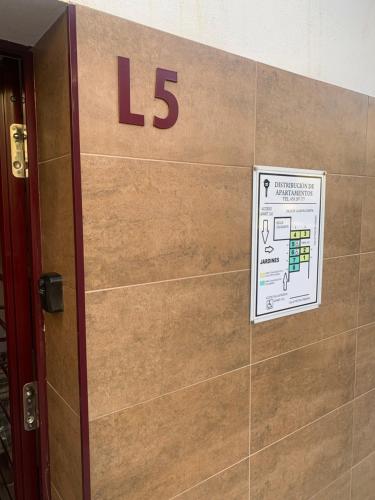 a sign on a wall with the number on it at Apartamentos Pintor Losada in Córdoba