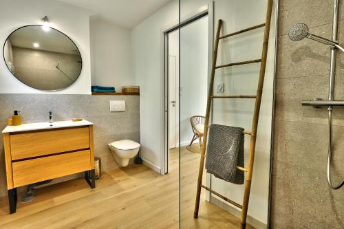 a bathroom with a shower and a sink and a mirror at La longère de Poulrinou in Bohars