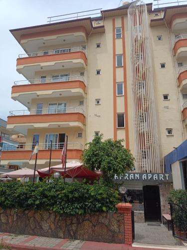 a building with a sign in front of it at Safran Apart Hotel in Alanya