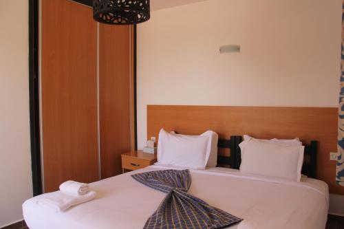 a hotel room with two beds with towels on them at Dakhla Camp in Dakhla