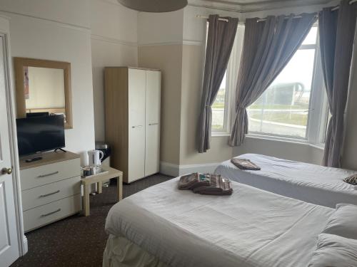 a hotel room with two beds and a television at The Waterside in Redcar