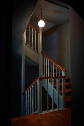 a staircase in a house with a light on the ceiling at The Townhouse in Udine