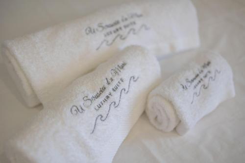 two towels sitting next to each other on a table at U Scrusciu d’u Mari Luxury Suite in Cefalù