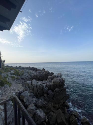 a view of the ocean from a rocky shore at U Scrusciu d’u Mari Luxury Suite in Cefalù