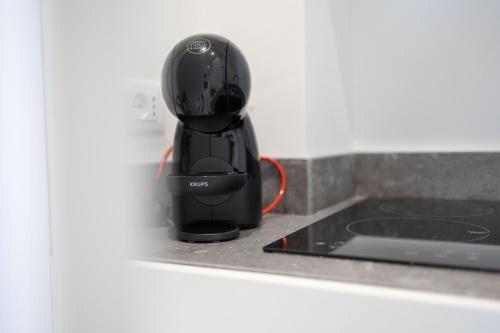 a black appliance sitting on top of a kitchen counter at U Scrusciu d’u Mari Luxury Suite in Cefalù