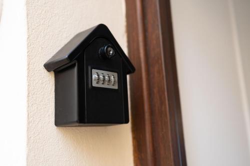 a black lightswitch on a wall next to a door at U Scrusciu d’u Mari Luxury Suite in Cefalù