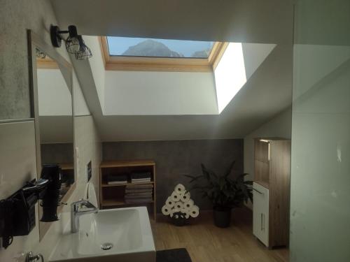 a bathroom with a sink and a skylight at Jochelerhof in Strass im Zillertal