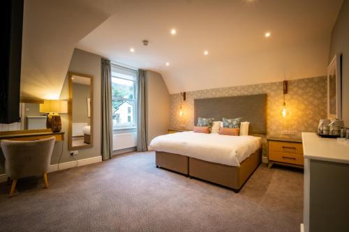 a large bedroom with a bed and a window at Ambleside Fell Rooms in Ambleside