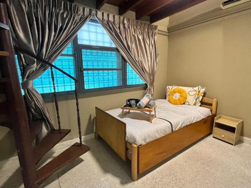 a bedroom with a bed with a large window at Lasam Heritage Villa + Glamping in the House 24pax with Karaoke & Snooker in Ipoh