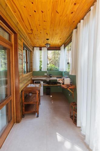 a bathroom with a wooden ceiling and a desk at Pousada Canto da Nascente in Monte Verde