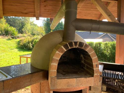an outdoor pizza oven sitting under a roof at Ubytování Čeladná in Čeladná