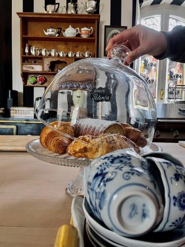 a glass display case with pastries on a table at Relais Villino Rubini in Brunate