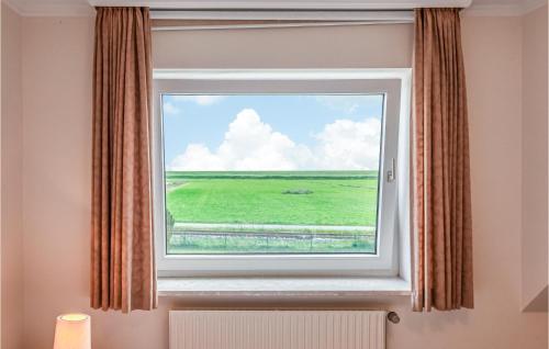 a window with a view of a green field at 2 Bedroom Lovely Apartment In Dagebüll in Dagebüll