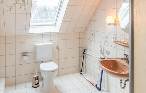 a bathroom with a toilet and a sink at 2 Bedroom Lovely Apartment In Dagebüll in Dagebüll