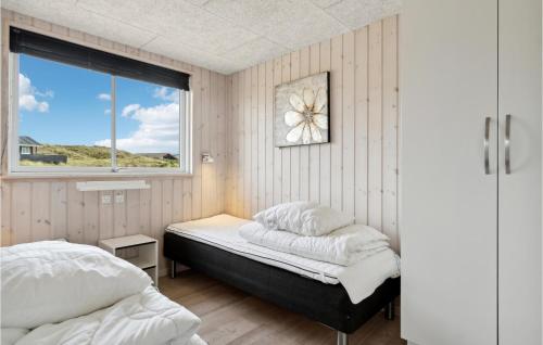 a bedroom with two beds and a window at Amazing Home In Hvide Sande With House A Panoramic View in Havrvig