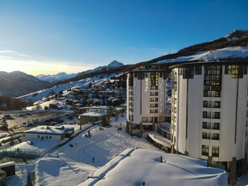 arial view of a city in the snow with buildings at Hotel Club Uappala Sestriere in Sestriere