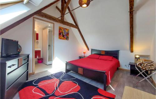 een slaapkamer met een rood bed en een televisie bij 6 Bedroom Lovely Home In Trguier in Tréguier