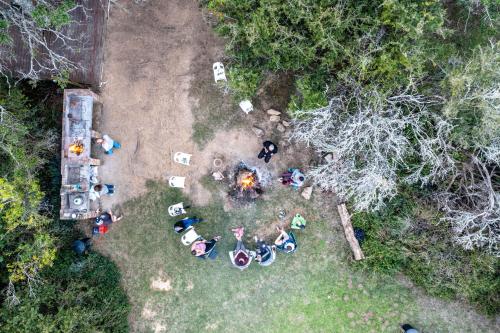 an overhead view of a group of people sitting around a campfire at Mansfield Private Reserve in Port Alfred