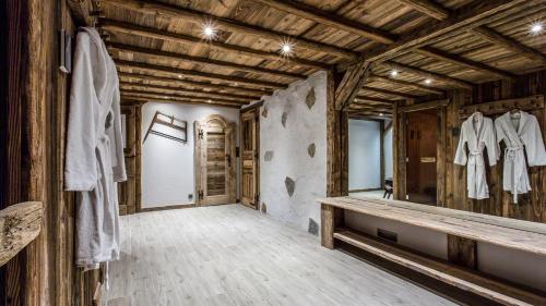 a dressing room with a mirror and wooden walls at Chalet Chal'heureux + Annexe in Chamonix-Mont-Blanc