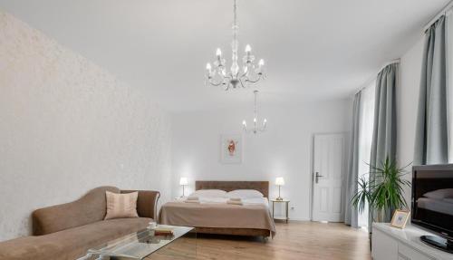 ein Wohnzimmer mit einem Sofa und einem Bett in der Unterkunft Garni Hotel VIRGO in Bratislava