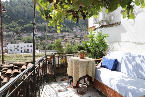 a balcony with a table and a view of a city at Badejani Room in Berat