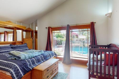 a bedroom with a bed and a window and a crib at Lowell Place in Fremont