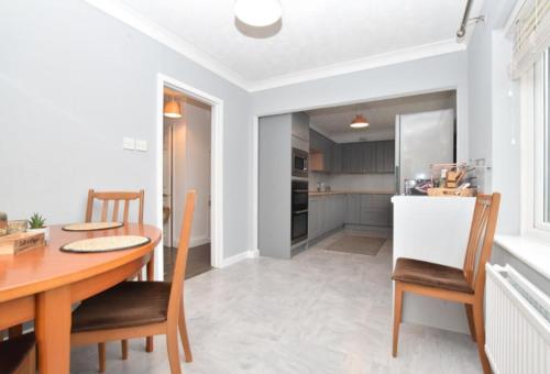 a kitchen and dining room with a table and chairs at Extensive 4 bed close to Peterborough in Ramsey