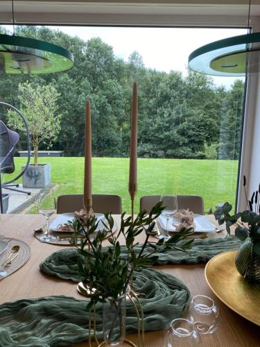 a dining room table with a green table cloth and candles at Eifel-Mosel-Hideaway in Landscheid